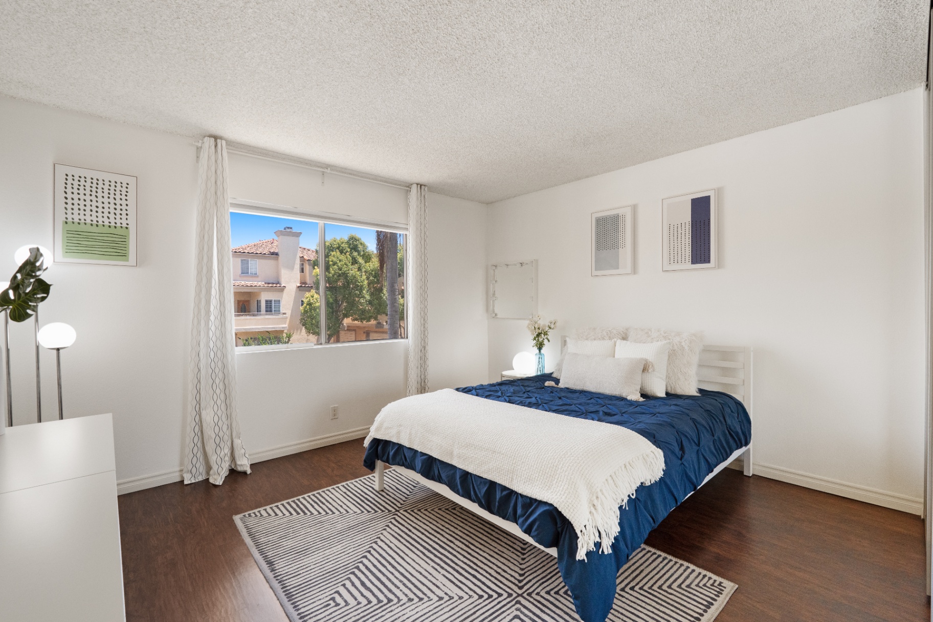 Bedroom with large picture window and neighborhood view