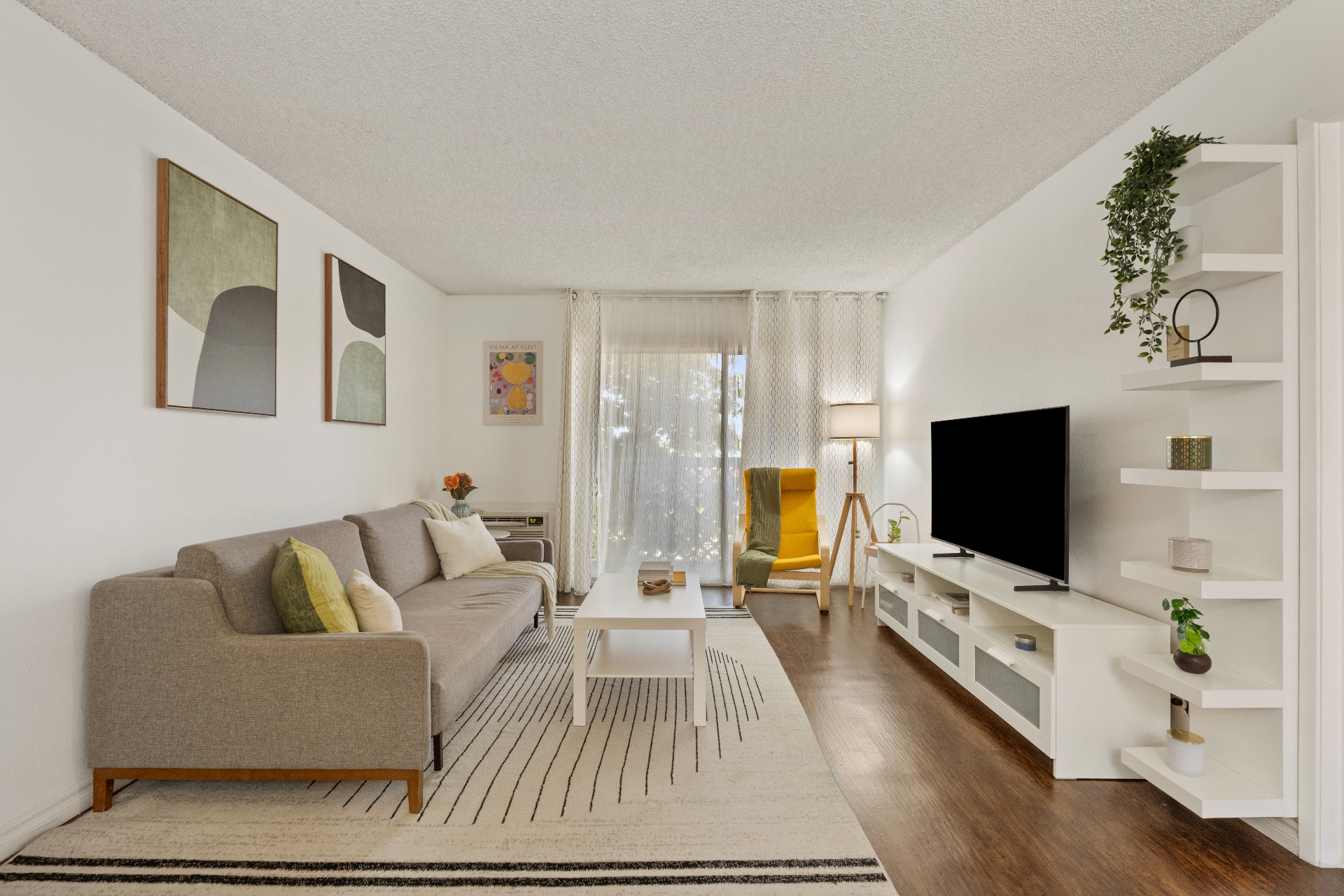 Living room with sofa, chair, and patio slider at 3565 Linden Ave #141