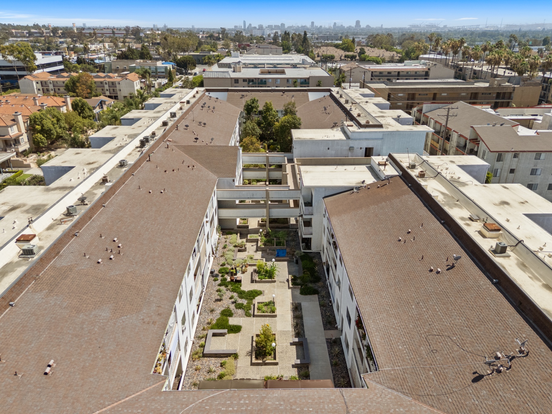 Aerial view over the community with the Port of Long Beach and skyline beyond