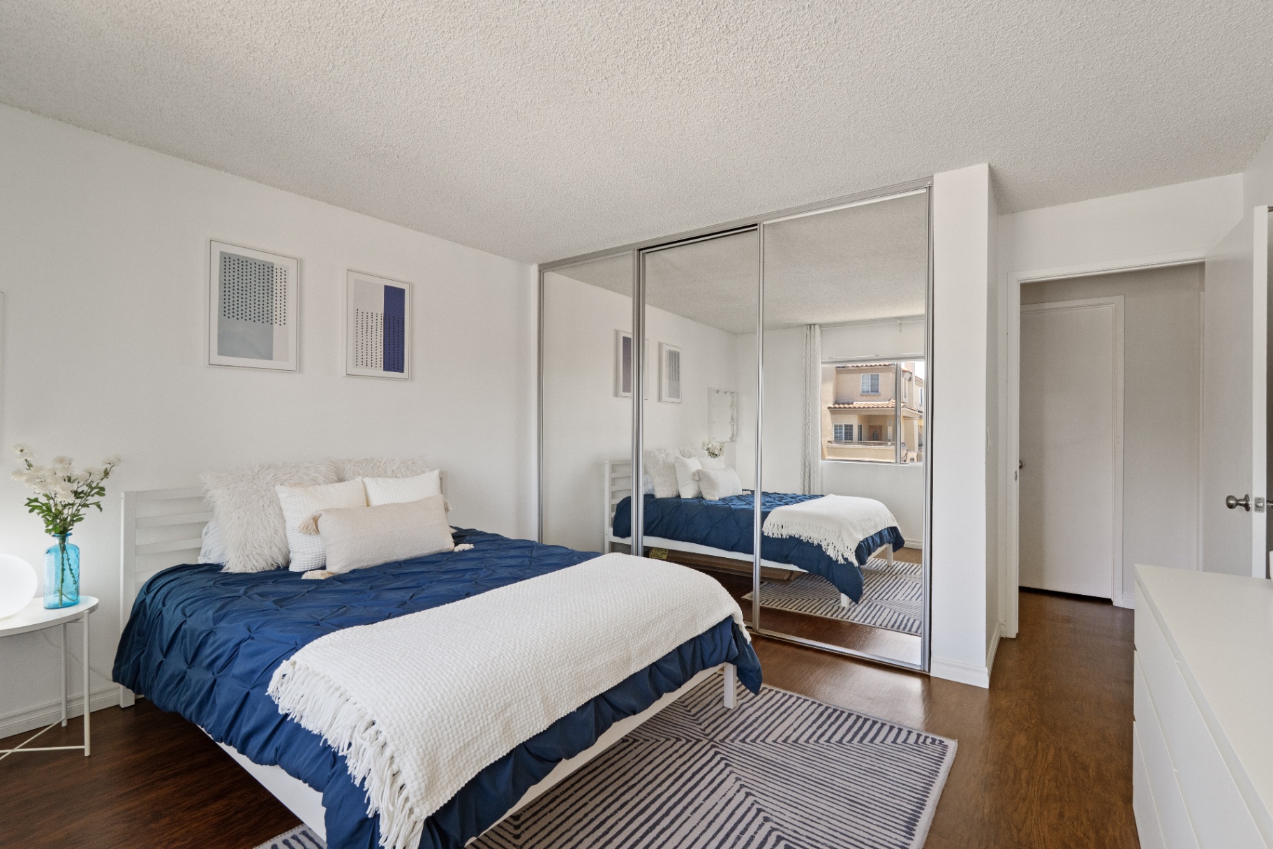 Bedroom showing mirrored closet doors and dresser